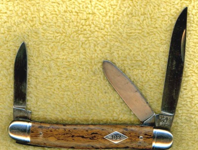 This is a knife with DNA from 3 companies: The Ulster name, the Schrade Old Timer number on the tang, and the Imperial shell handle construction as well as the DE (Diamond Edge) shield.
<br />
<br />Very Strange!