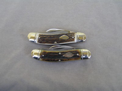 Ohio - NOTICE 4 PINS on the REAL one. Check out the stag on the bottom one