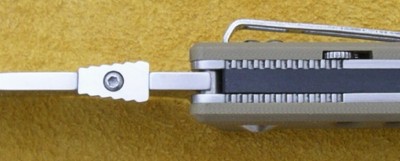 Slide tab in upper handle back to disengage blocking stud