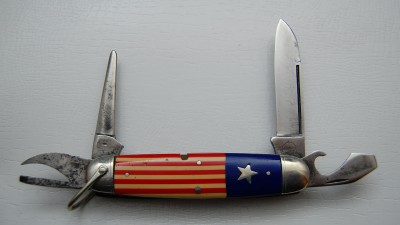 Remington UMC Circle #3335, Red, White &amp; Blue Celluloid Covers, 3 3/4” closed<br />Long pull spear blade is 90% full and a tad sluggish, lined nickel silver bolsters<br />Inlaid star shield and a slightly tipped awl but overall a very fine example of a very rare knife!