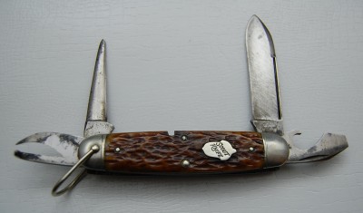 Remington UMC Circle #3333, Brown Bone Covers, 3 3/4” closed<br />Spear blade is 95% full with some grind marks, lined nickel silver bolsters and a slightly kinked bail<br />Acorn “Scout Knife” shield and a full partially blued awl make this a very fine example!