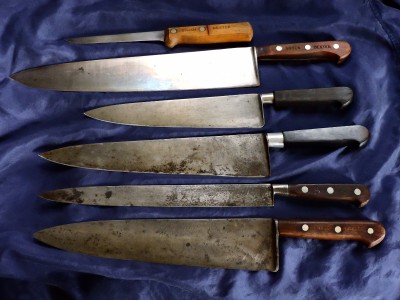 Large chef knives (10", 12", 14") and a slicer and a boning knife.