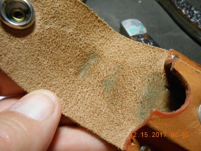 Notice the greenish area on the leather, where the verdigris began.