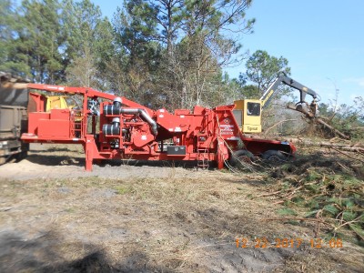 This is the chipper. 700 hp Cat diesel, it is being fed by a loader and you can see the chips being blown into a trailer.