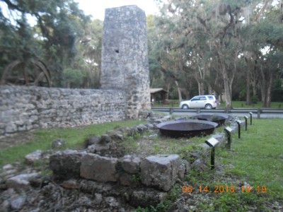 The flue/stack for the boiler that powered the big cane mill and the remains of the kettles used in turning the cane juice eventually into sugar.