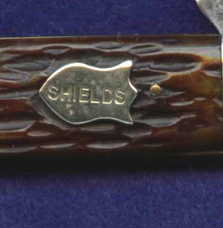 This shield is on a two blade utility pen knife. I have no idea who &quot;Shields&quot; might have been.