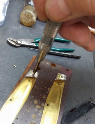 Not pivot pins out the inside with snap punch