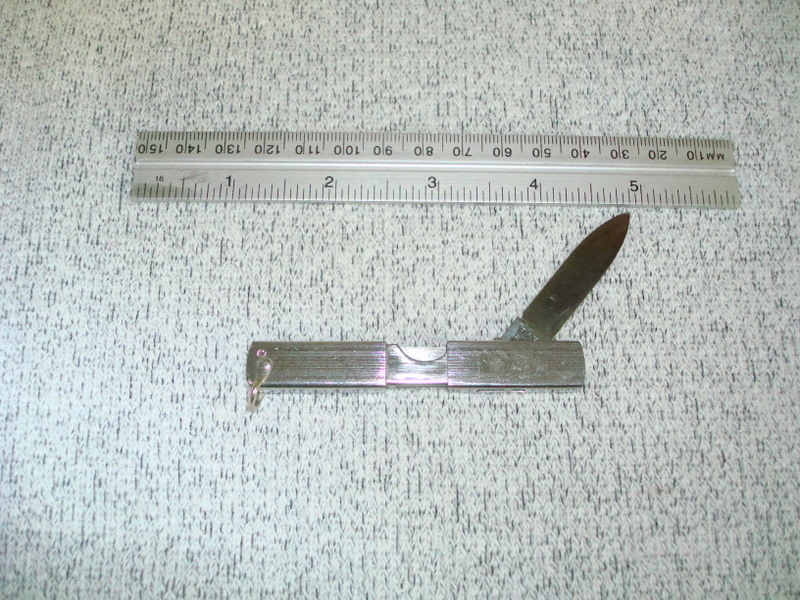 This one has a sleeve that slides to the right so that the small slot in the bottom exposes the sqared end of the blade.  Grab the nail nick and swing out the blade, then slide the sleeve back to the left to lock the blade open.  Hard to describe until seen in action.