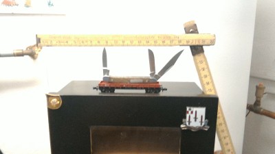 1 of my 2 EDC's - A small Winchester w/an upside down shield. :-) Sittin on a N size Railroad car.