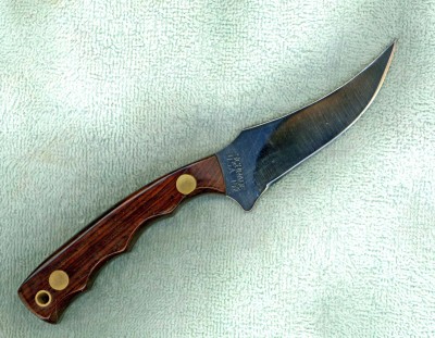 The handle on this knife is Mexican Kingwood. I used a polyurethane finish on this handle and after three days it was still not dry, and this was during 90° heat! It turns out that there are so many oils in Kingwood that normal finishes will not work on it, they just won't dry. I had to consult with an exotic hardwood specialist to get a formula for a mixture of finishes that worked. It looks nice when I was finished. Beautiful wood!