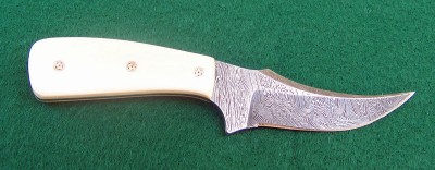 The handles on this knife are fossilized mammoth ivory held on by mosaic pins.
