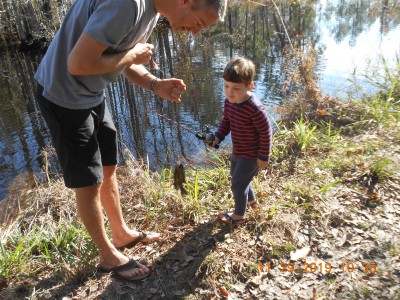 Daddy raised him over the so he could see his 1st fish.