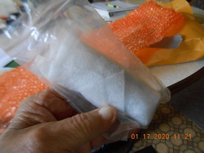 Inside the Tupperware among adequate bubble wrap and foam, I found a small ziplok bag full of foam wrap.  Inside that were 2 Queens.