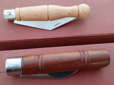 Here they are closed. The mystery knife has a relatively short blade.