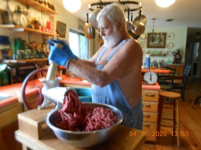 Grinding venison with no fresh haircut and an untrimmed beard.