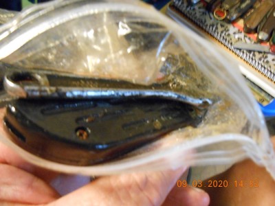 Looking into the contents, I spotted a small zip lock bag that was sure enough nasty! Inside was some sort of knife and a 4" adjustable wrench that were frozen up.  After I opened it I had to have Miss Joy snap the picture as my paws were covered in poo(some sort of lubricant).