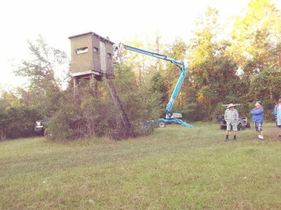 One man working, the rest standin' around. That's my friend Roger in the ugly Gator jacket and the older gentleman is the father of the man in the bucket.