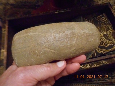 Stone head, not as detailed as the other.