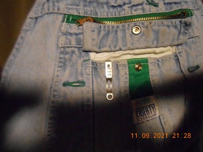 A raggedy old SOG, in the breast pocket, ready for use.