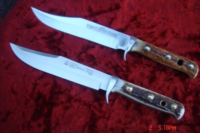On the top is a 1967 bowie - what a gem- and below is  the 2009 model - still a beautiful knife BUT you can feel the difference, the newer mod is lighter, and less attention to detail in finish and blade shape. And of course, carbon steel on the old versus stainless on the new....