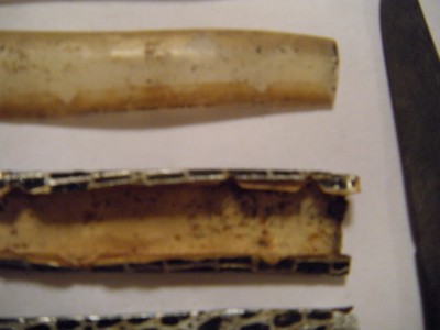The tin foil is printed with designs and sometimes perforated. <br />It is wrapped over paper, then covered with a clear cell wrap. The clear cell wrapes<br /> will not  be re-used to complete the restoration. <br />It will have a clear coat of enamel  instead.