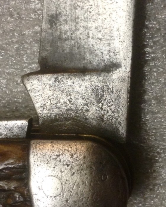 The Main Blade Front Tang Stamp.<br />It "Probably" Says, "ROBESON (over) ShurEdge (over) CUTLERY"